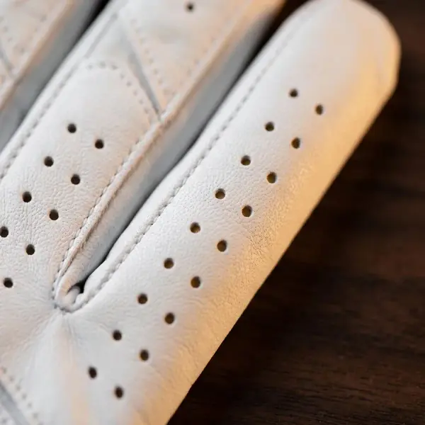 Rows of perforations along the fingers